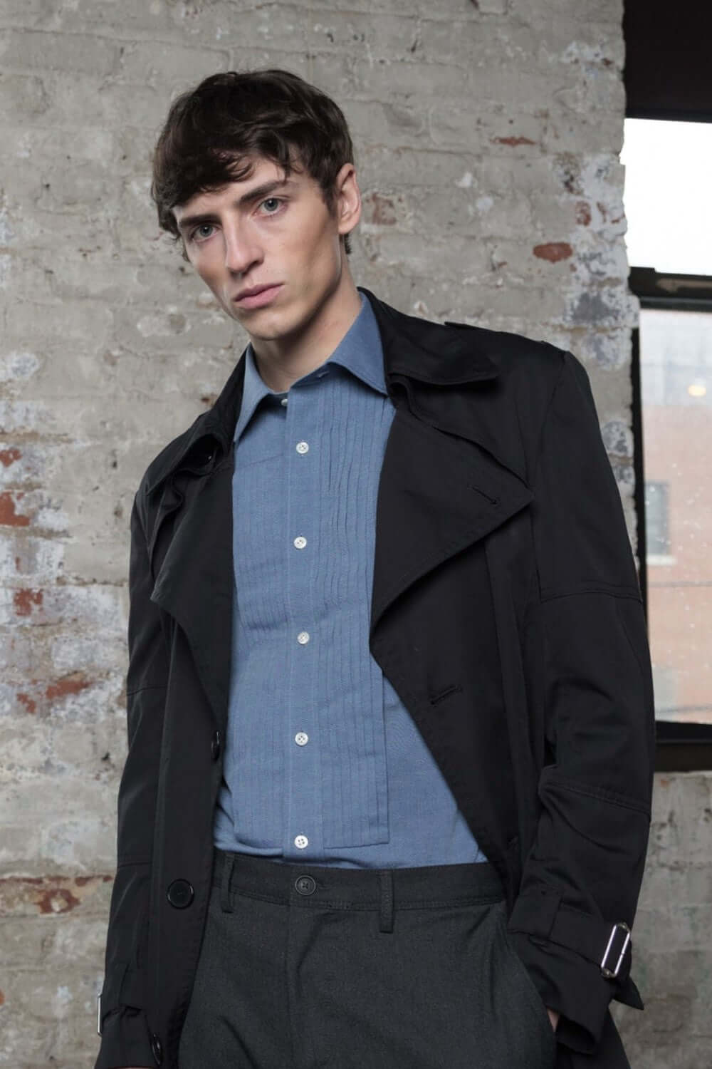MODEL WEARING ESSEX(LIGHT BLUE)LUXURY CHAMBRAY SLIM FIT HIGH-END SHIRT 100%PREM.COTTON WITH BLACK TRENCH COAT